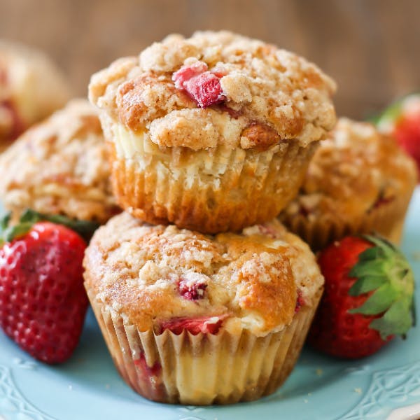 stack of two strawberry cheesecake muffins on a blue plate