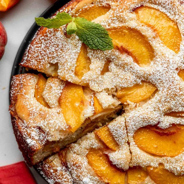 single layer fresh peach cake in a springform pan