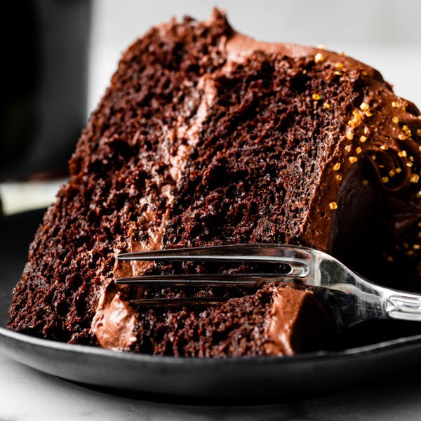 slice of chocolate cake on a black plate