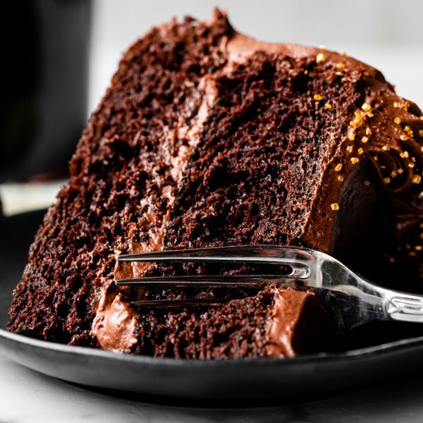 slice of chocolate cake on a black plate