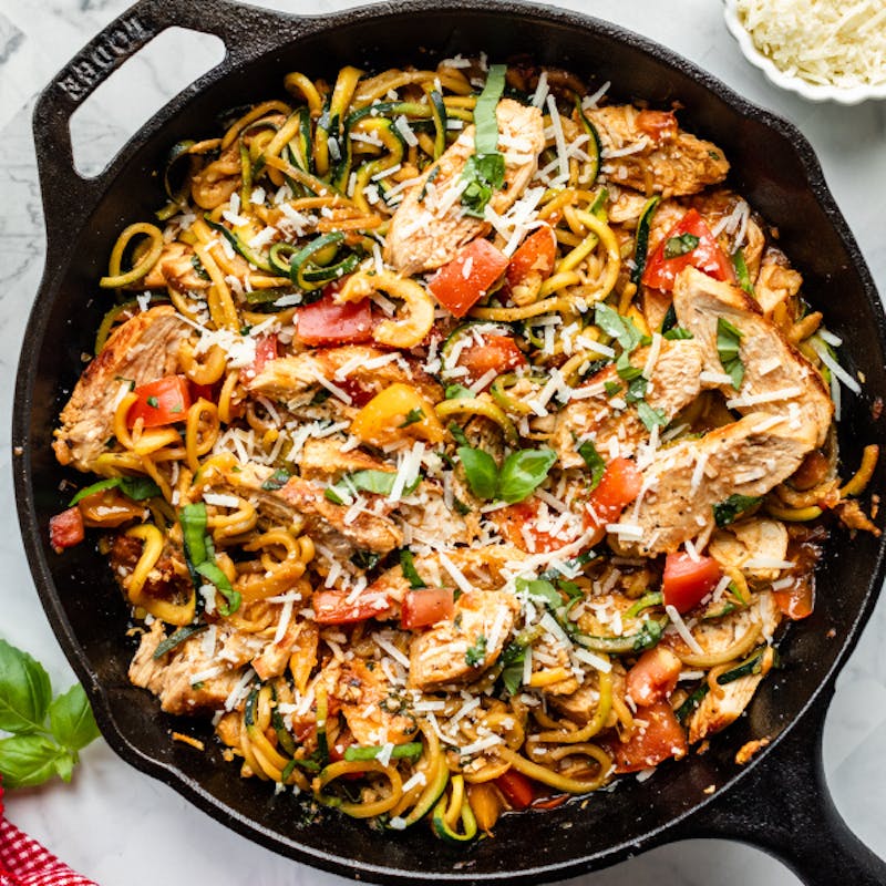 bruschetta chicken and zucchini noodles in cast iron skillet