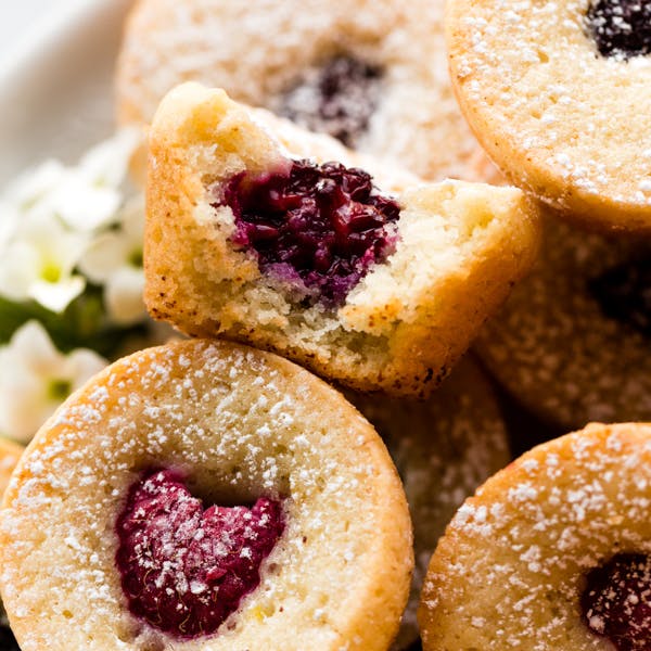 picture of brown butter tea cakes with raspberries in the center