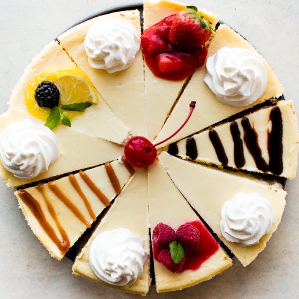 sliced cheesecake with assorted toppings