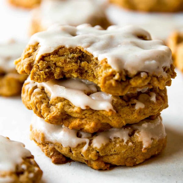 three brown butter pumpkin oatmeal cookies with icing