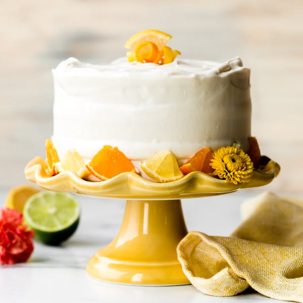 citrus cake on yellow cake stand