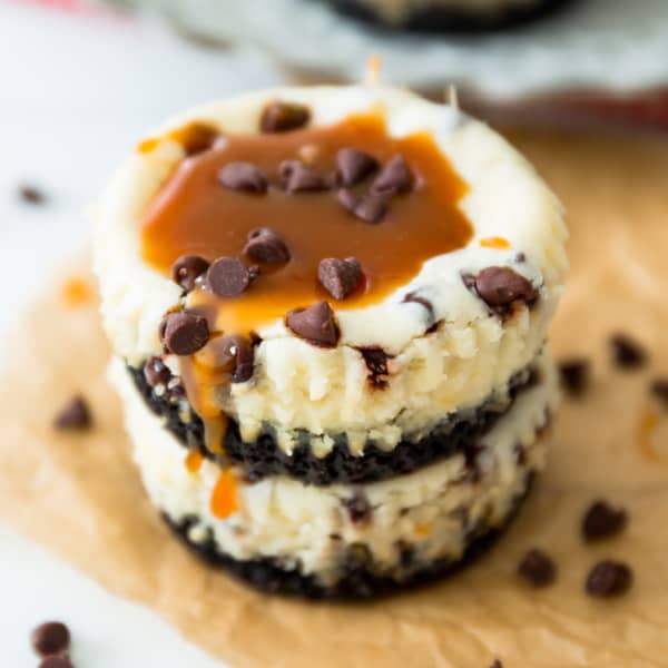 stack of two mini cheesecakes with chocolate chips and topped with salted caramel sauce
