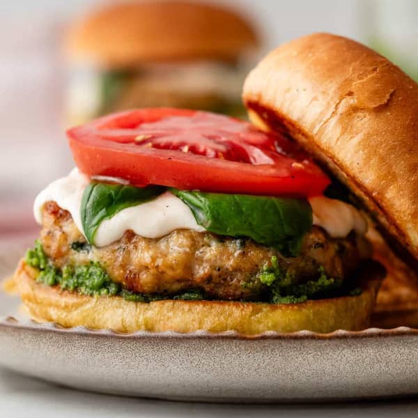 chicken burger with pesto, mozzarella, basil and tomato