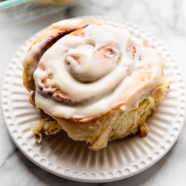 picture of a giant cinnamon roll with icing on a plate