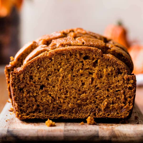 picture of a sliced loaf of pumpkin bread on a cutting board