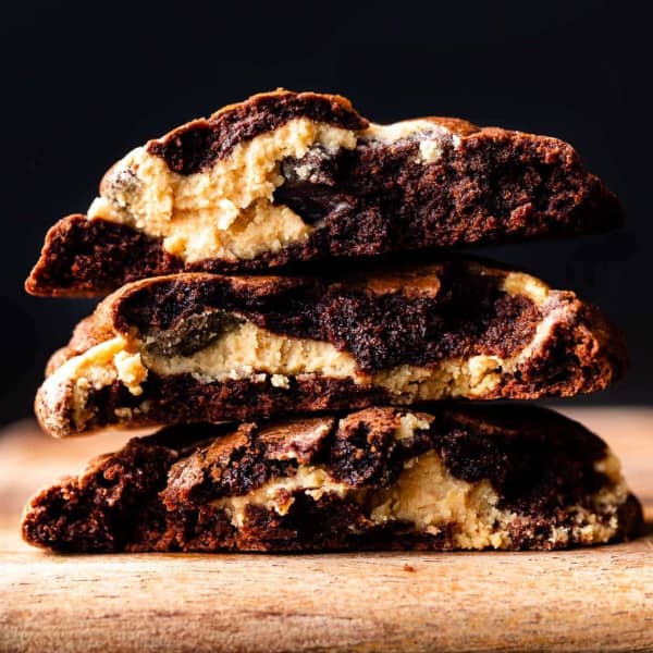 brownie cookies stack, broken in half, showing peanut butter swirl