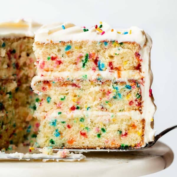 slice of three layer confetti cake