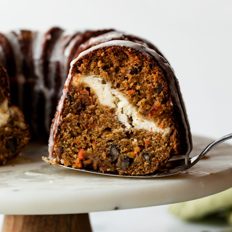 Picture of a slice of cheesecake swirl carrot bundt cake