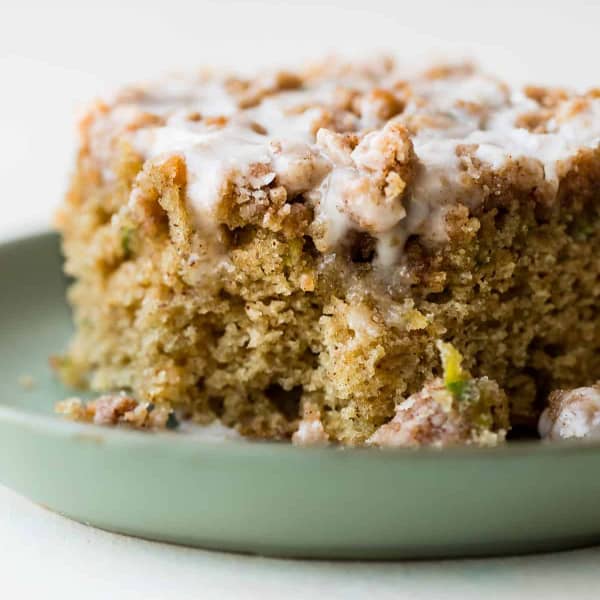 slice of zucchini crumb cake with icing
