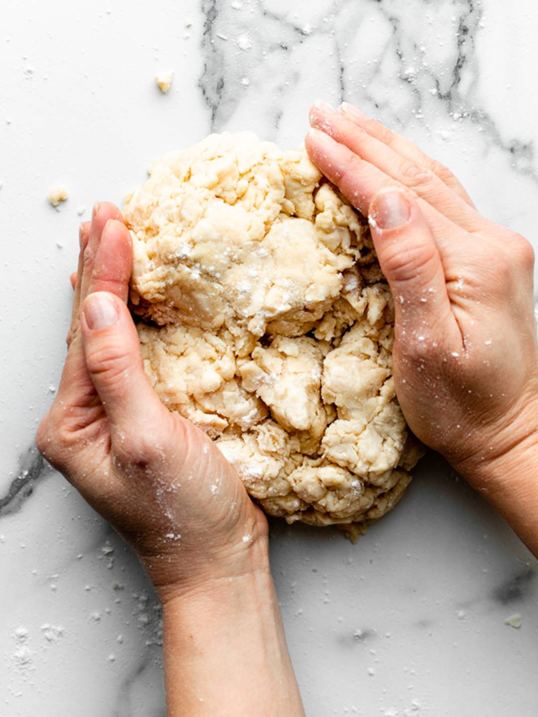 hands forming dough into ball