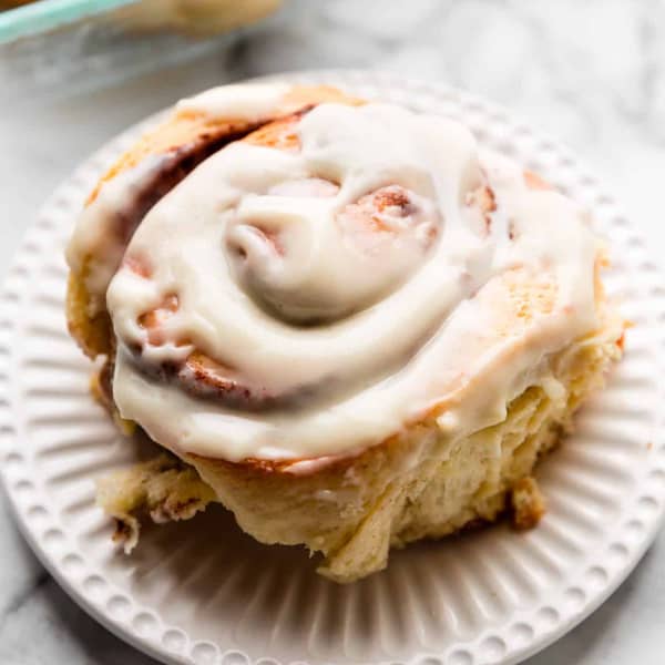 XL cinnamon roll on a plate with icing