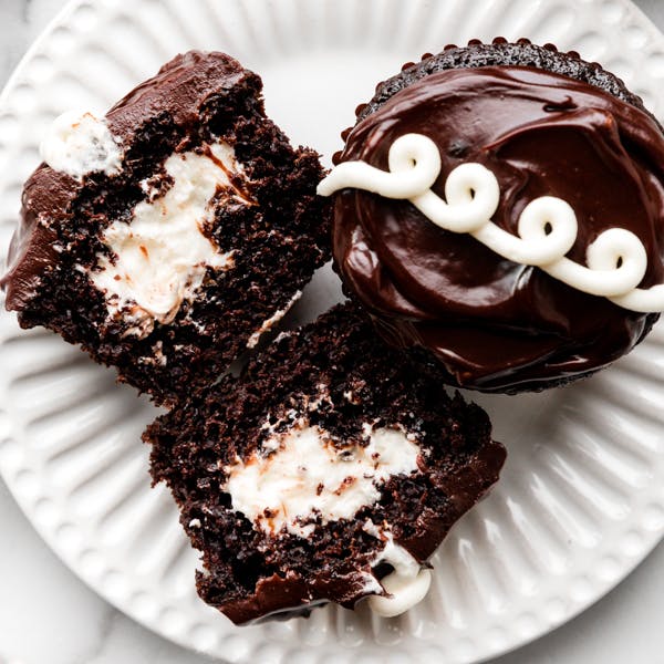 cream-filled chocolate cupcakes on white plate