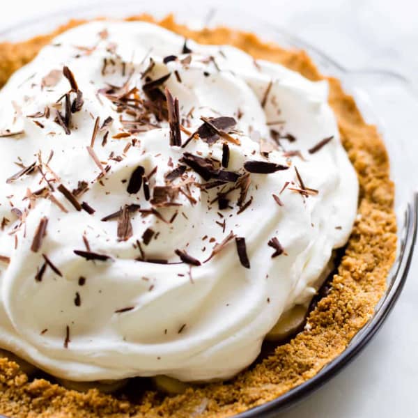 Homemade whipped cream topping a pie with chocolate shavings on top