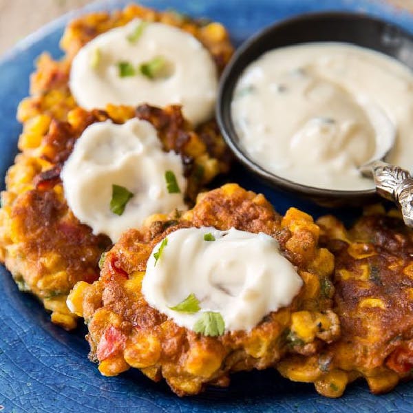 picture of corn fritters served with jalapeno honey yogurt sauce