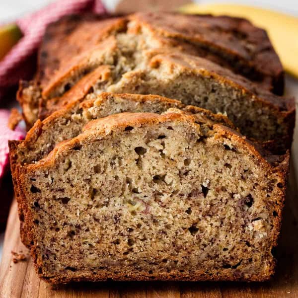 banana bread slices on wooden cutting board