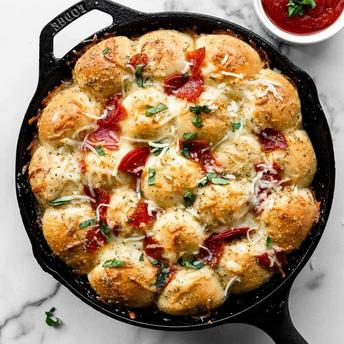 pizza pull apart rolls in a cast iron skillet