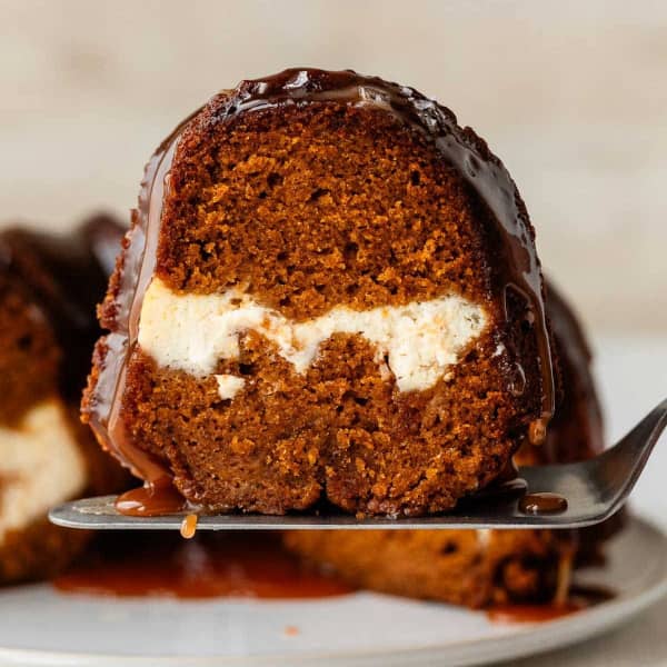 slice of pumpkin bundt cake with cream cheese swirl