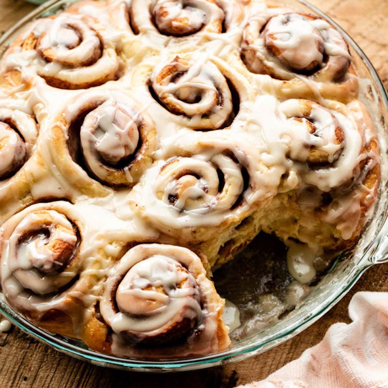 cinnamon rolls in pan with icing on top