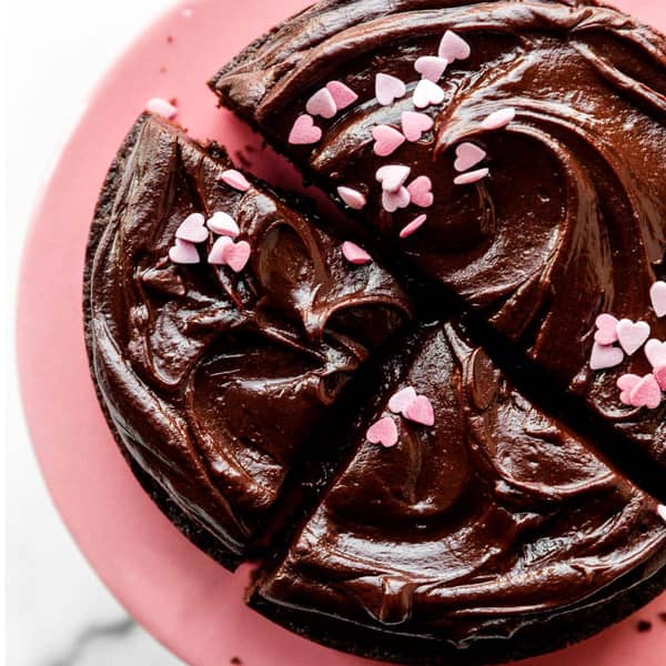 6 inch chocolate cake topped with chocolate ganache and pink heart sprinkles