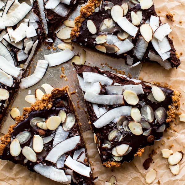 slices of tart with coconut and almonds on top