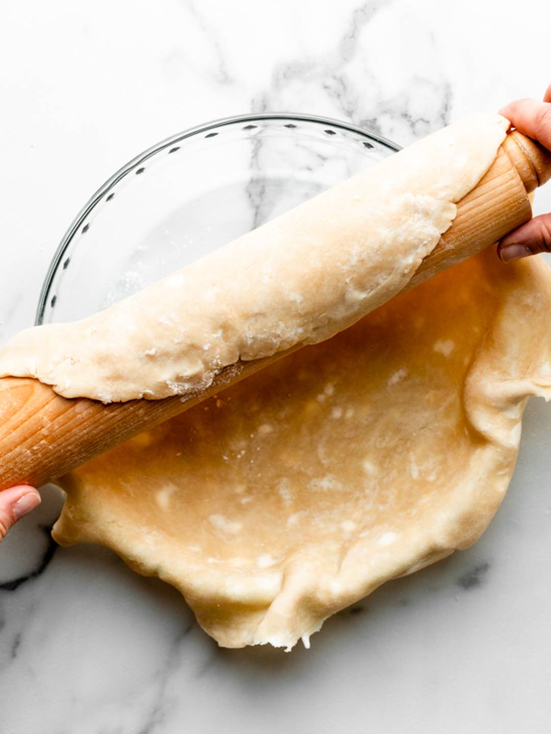 draping pie dough over pie dish