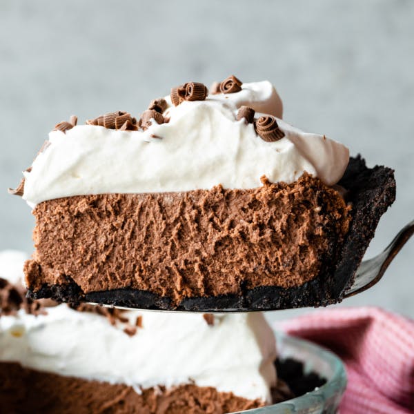 French silk pie slice being lifted out of a pie dish