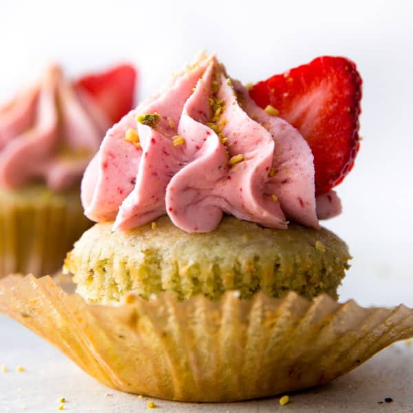picture of pistachio cupcake with strawberry frosting