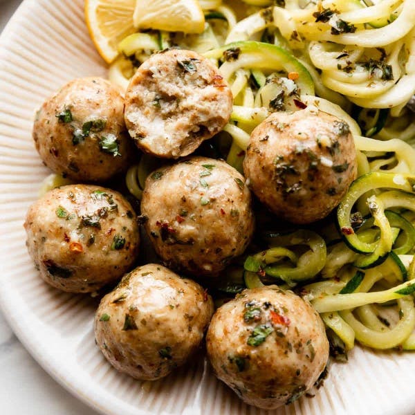 chicken meatballs on a plate with zucchini noodles