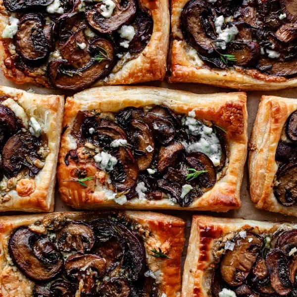 flaky puff pastry tarts topped with mushrooms gorgonzola thyme and sea salt