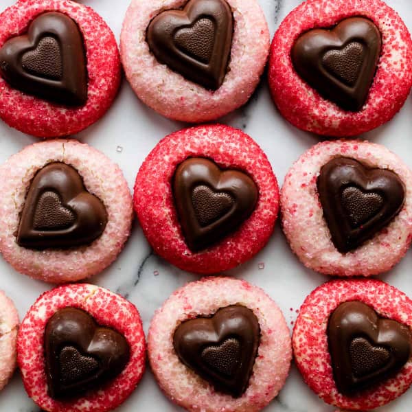 drop cookies coated in pink and red sprinkles, with a chocolate heart on top