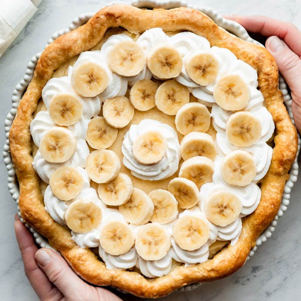 banana cream pie with whipped cream and bananas on top