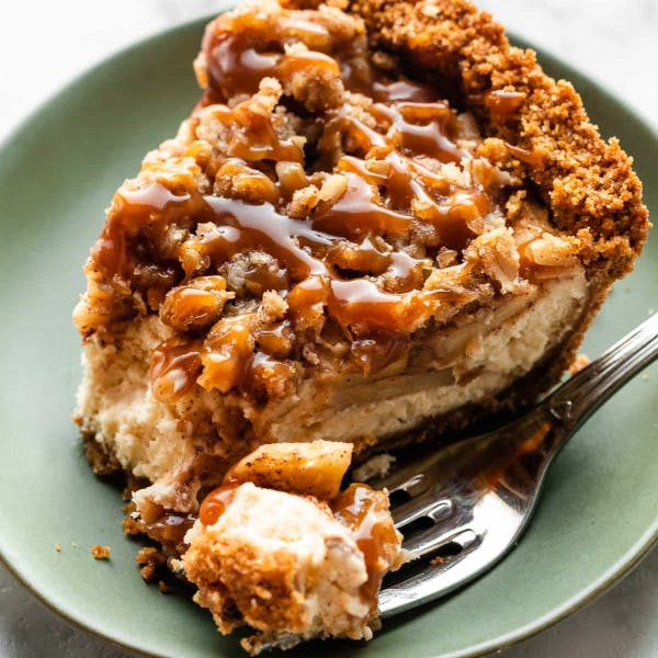 slice of caramel apple cheesecake pie on a green plate