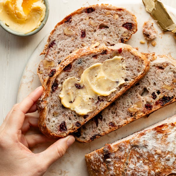 slices of cranberry nut bread with honey butter