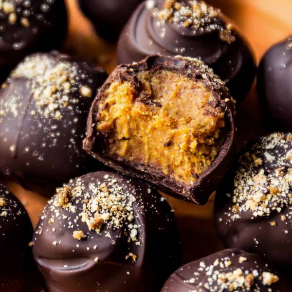 pumpkin spice truffles covered in chocolate, with a bite taken out