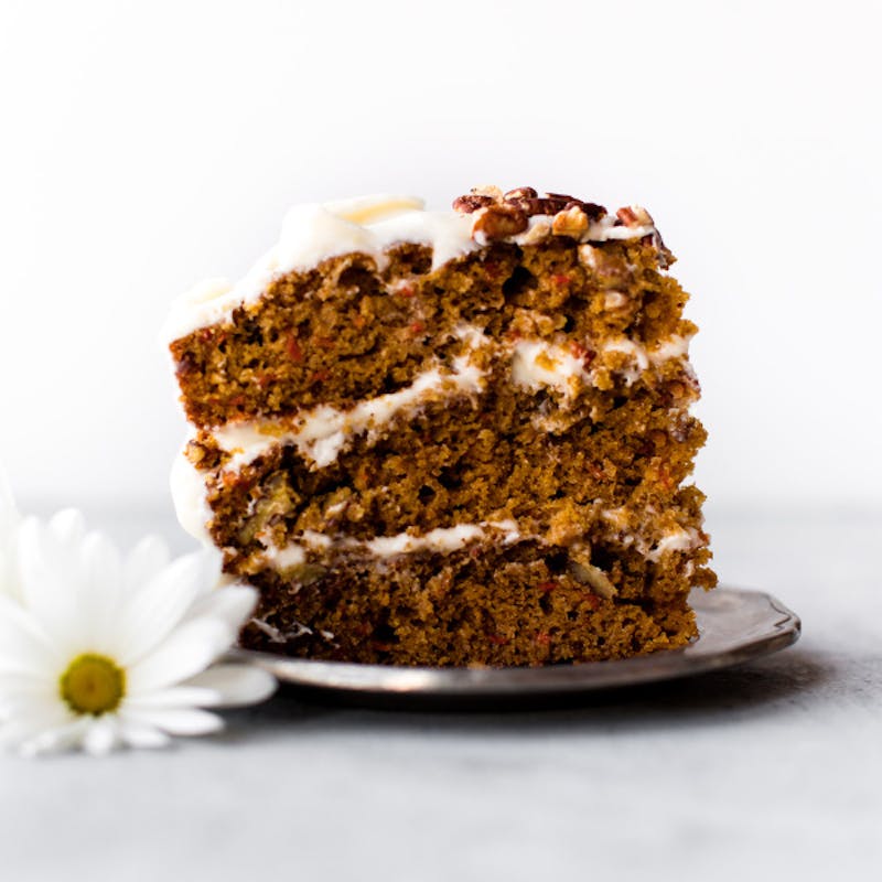 picture of a slice of carrot cake with cream cheese frosting 