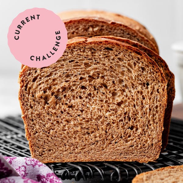sliced loaf of whole wheat bread with "current challenge" badge