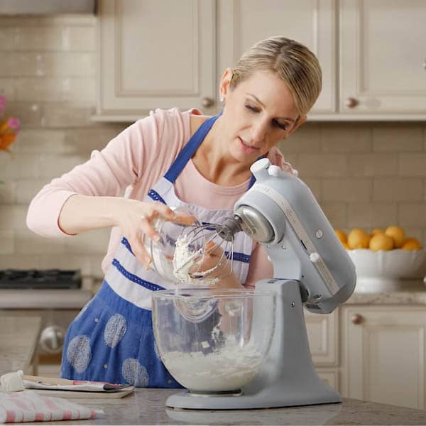 sally pouring sugar into mixing bowl
