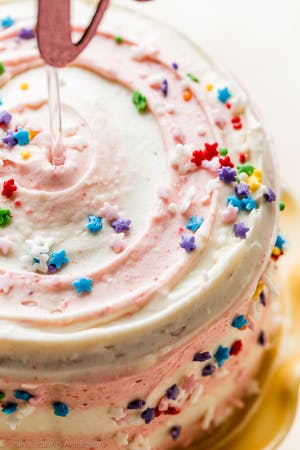 top of a cake with white and pink striped frosting