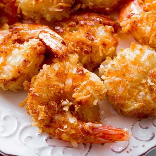 golden brown coconut shrimp on a white plate