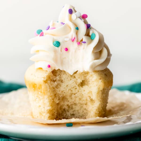 picture of a vanilla cupcakes with vanilla buttercream and rainbow sprinkles