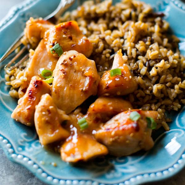 chili chicken with rice on blue plate