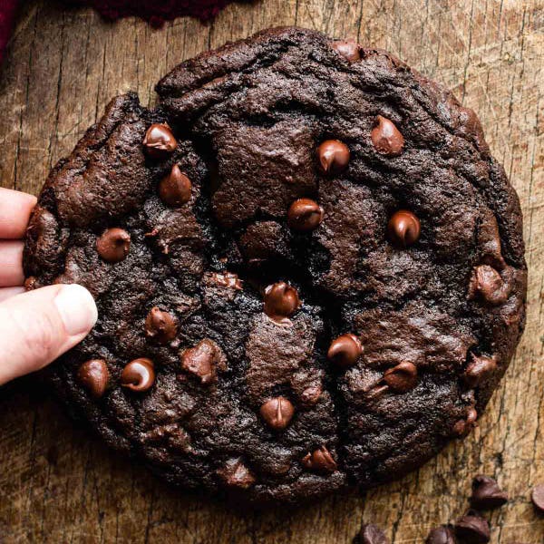 giant chocolate cookie with chocolate chips, broken in two