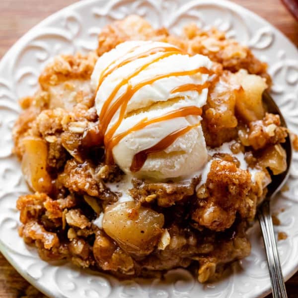 picture of apple crips on a white plate with vanilla ice cream on top