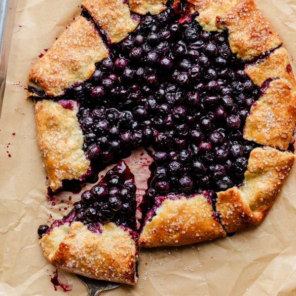 blueberry galette with a slice being removed