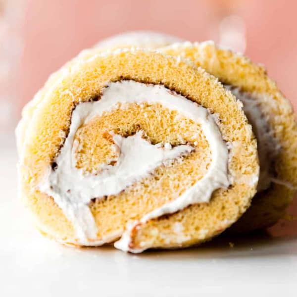 side view of champagne cake roll showing creamy white filling