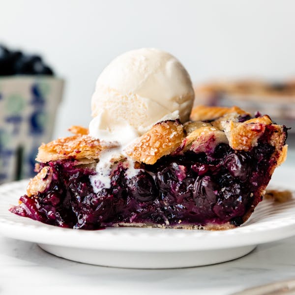 slice of blueberry pie with ice cream on top